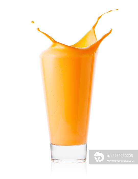 Splash in tall glass of carrot or orange smoothie or yogurt