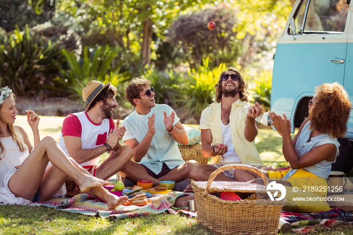 Group of friends having fun together near campervan