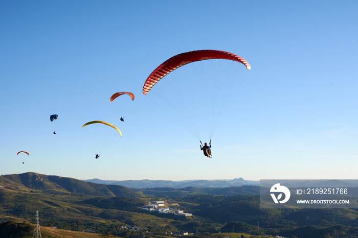 Paragliding flying over mountains