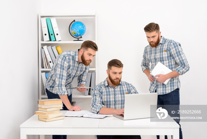 Group of businessman clones working together at the office