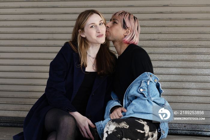 Lgbtqia friends sitting and posing together.