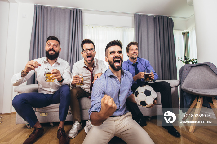 Excited men watching sport match, championship at home.