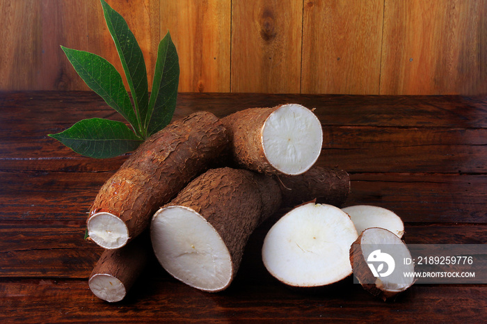 Organic cassava (mandioca, aipim, brazilian cuisine), fresh and raw on rustic wooden table