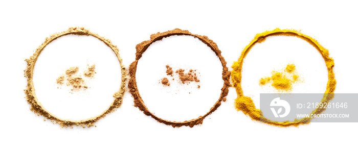 Circle of powder turmeric ginger and cinnamon on white background