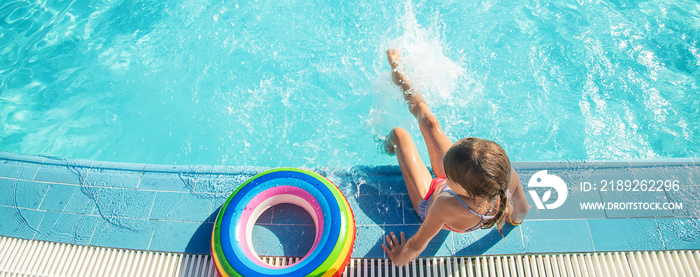 the child swims and dives in the pool. Selective focus.