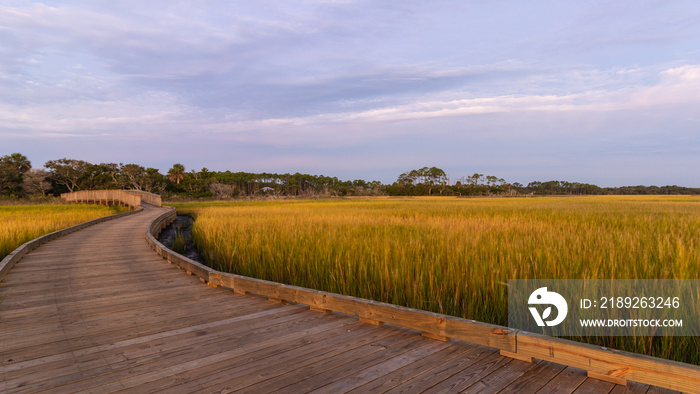 Sunrise and the boardwalk over the Palencia saltwater marsh in St. Augustine, Florida