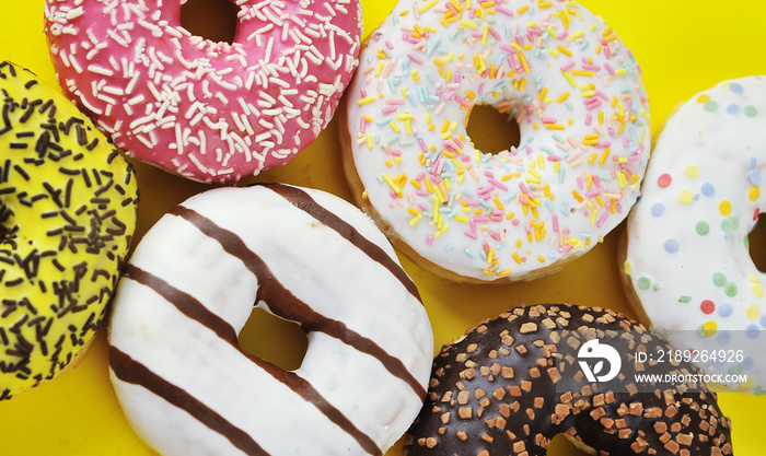 Delicious donuts on light pastel color background.