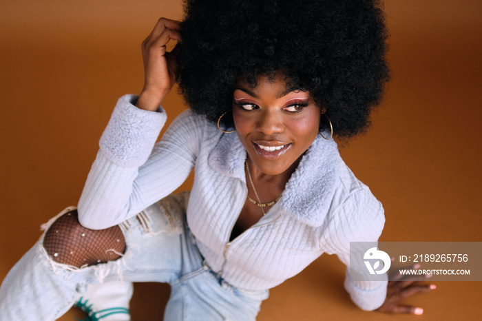 Studio portrait of young beautiful women with afro hair smiling