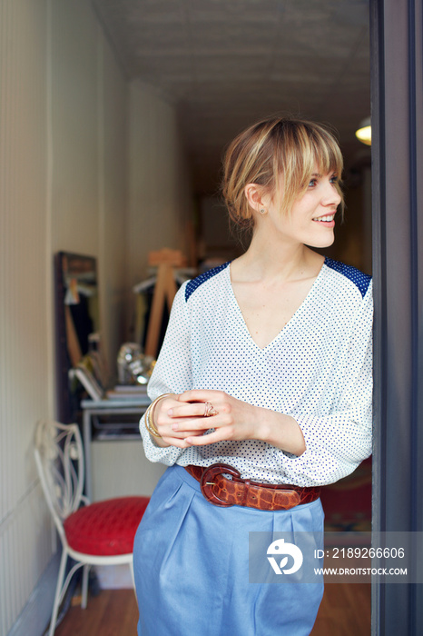 Smiling owner standing at doorway