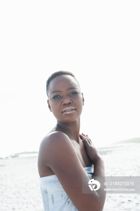 Portrait of young woman on beach, pensive expression