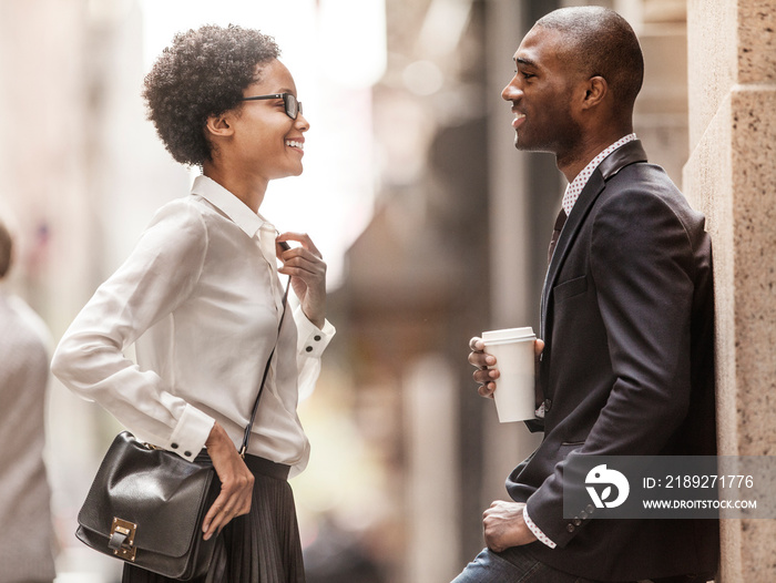 Man and woman talking on street