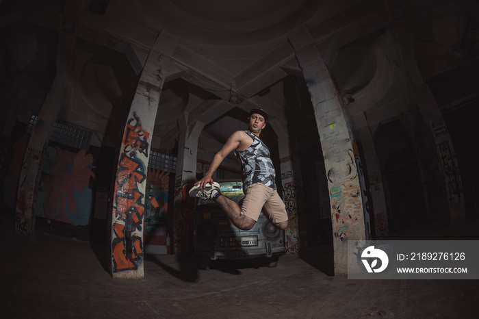 Mexican latinperformer jumping on abandoned building