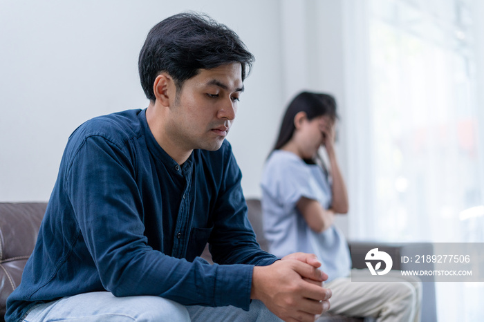 Asian man are disappointed and saddened after an argument with wife. Asian couples are having family