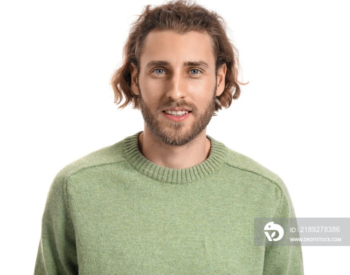 Handsome young man in knitted sweater on white background