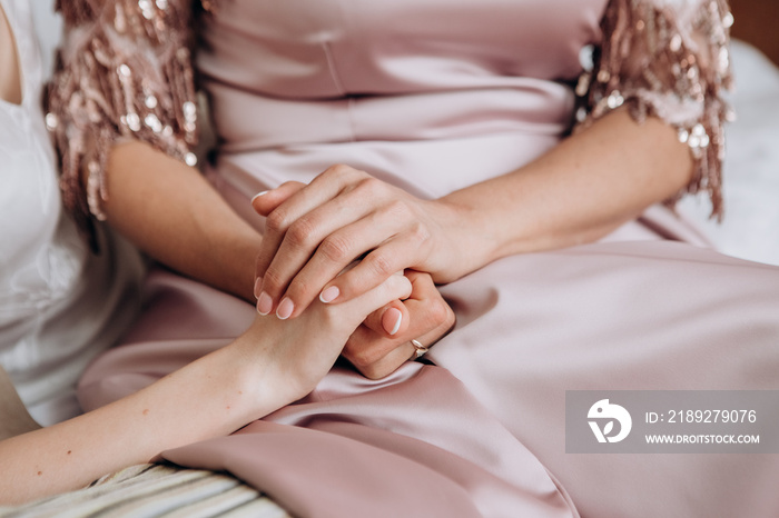 female hands bride mother wedding day inside