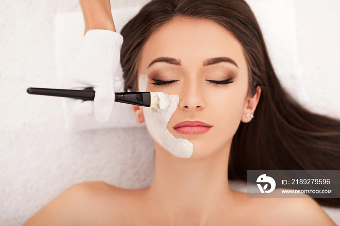 Beautiful Young Woman Getting a Face Treatment at Beauty Salon.