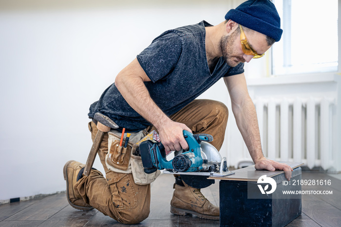 Circular Saw, carpenter using a circular saw for wood.