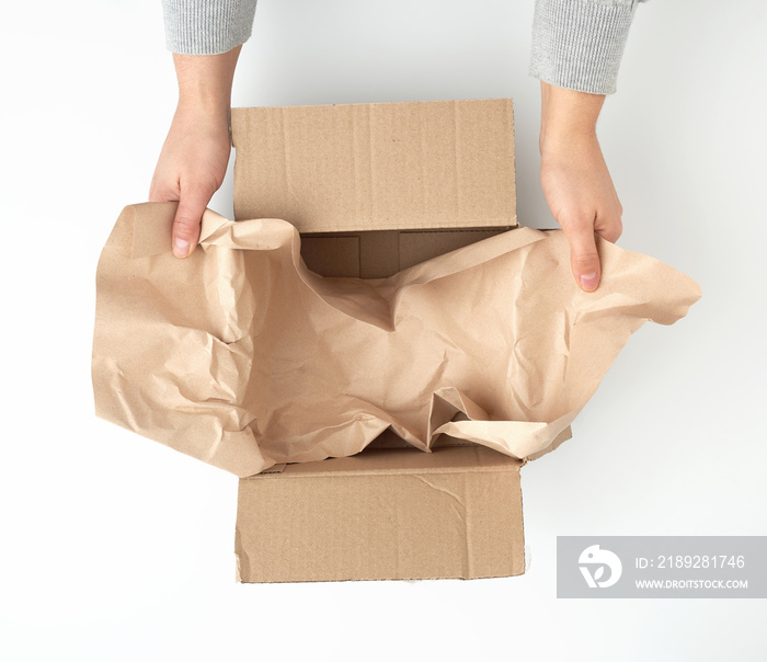 open empty square brown cardboard box for transportation and packaging of goods