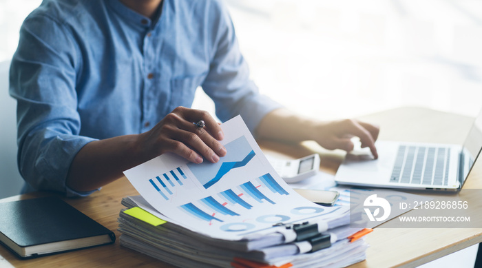 Work from Home, Businessman hands working in Stacks of paper files for searching information on work