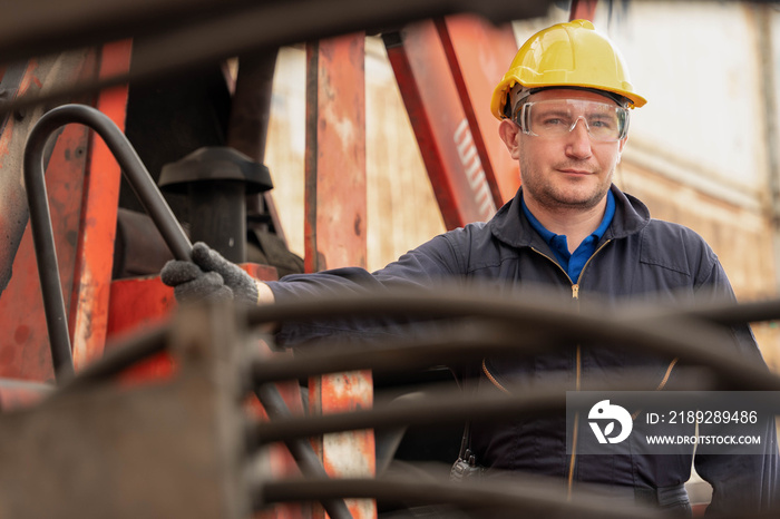 caucasian engineer at work at container yard and cargo with containers forklift