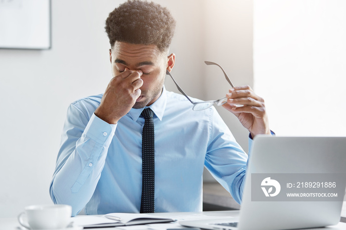 Business, people and work concept. Elegant businessman with dark skin and curly hair wearing formal 