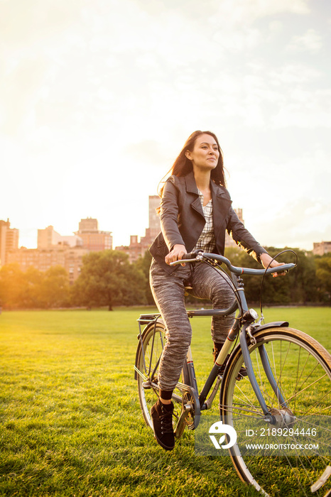 Young woman riding bicycle in Central Park