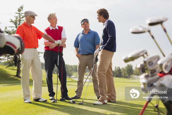 Golfing foursome having a conversation on golf green