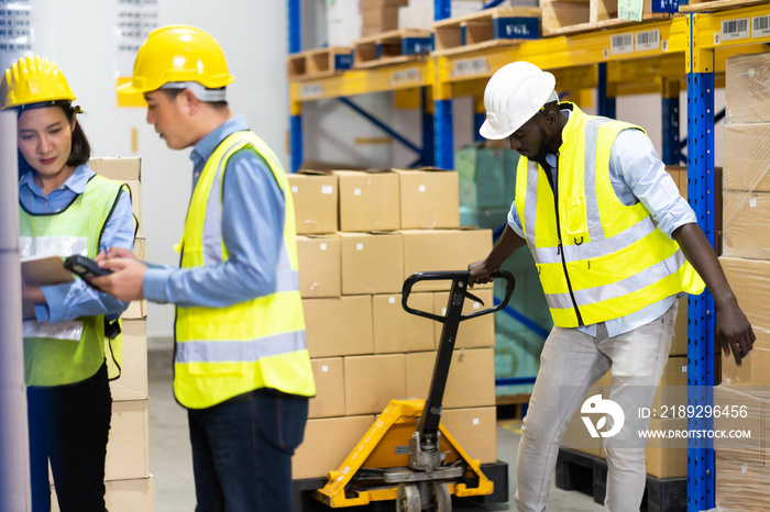 Black Male warehouse worker pulling a pallet truck. middle aged African American warehouse worker pr