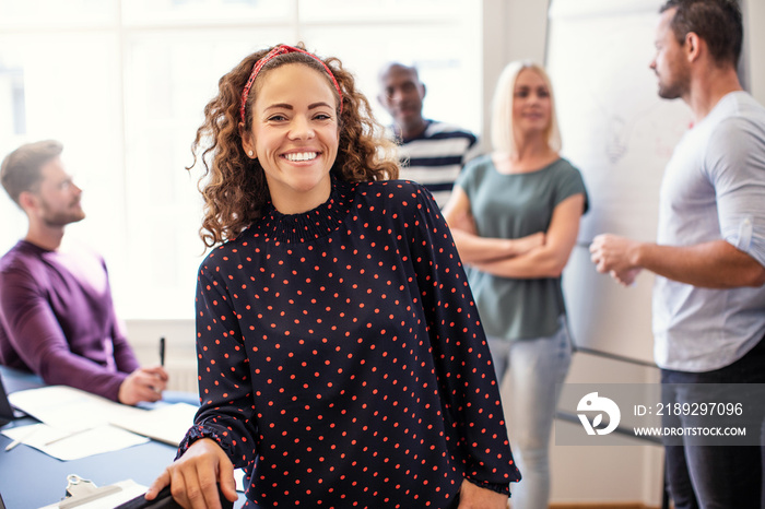 Smiling young designer standing in an office after a meeting