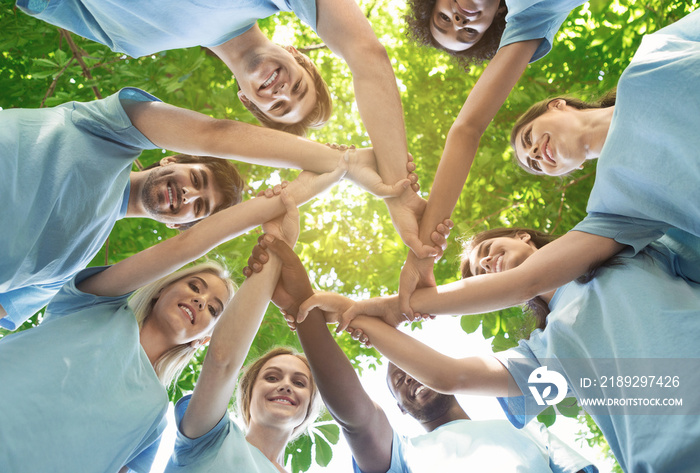 Group of happy volunteers collaborate at park