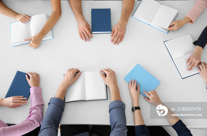 People sitting at table in book club