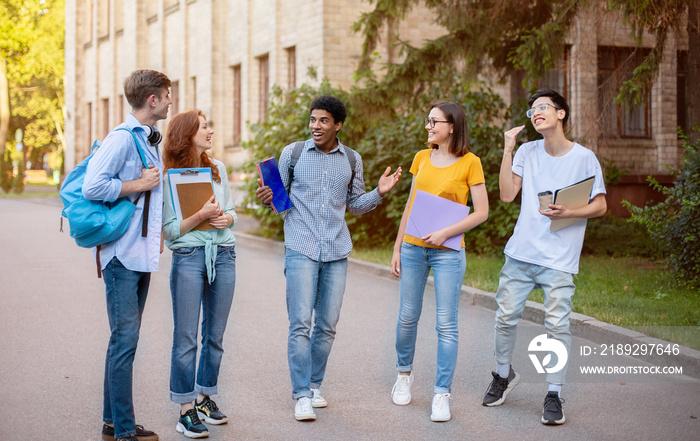 Multiethnic Freshmen Students Talking Walking In University Campus Outside