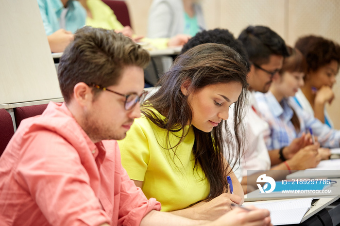 group of international students writing at lecture