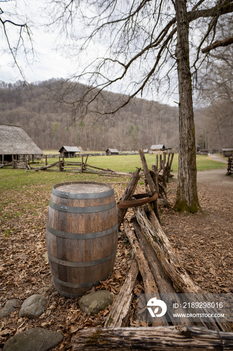 barrel next to a rustic fence in a historic site