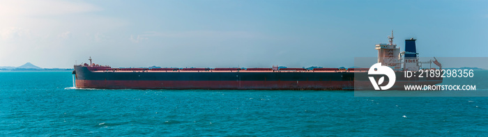 A large lightly loaded oil tanker sailing in the Singapore Straits in Asia in summertime