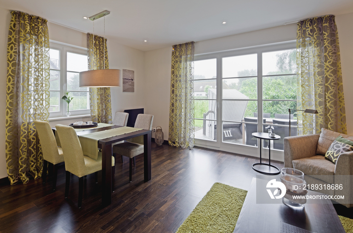 Open plan of dining area and living room in contemporary house