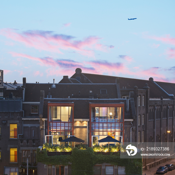 Apartment building against scenic sky at dusk