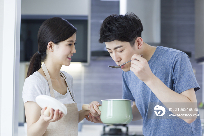 快乐的年轻夫妇在厨房做饭