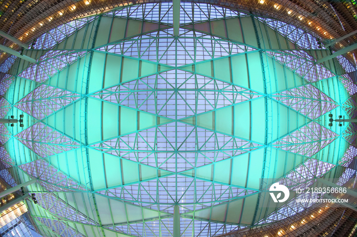 Birds eye view of intricate illuminated ceiling in modern office building