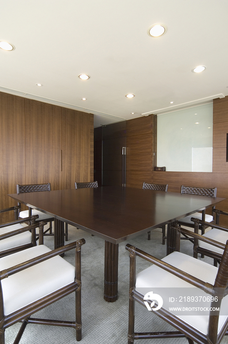 Table and chairs in conference room with the view of cityscape through window