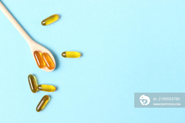 Omega-3 capsules on a colored background. Fish oil, healthy supplements