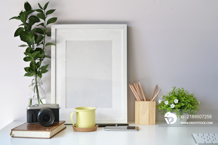 Mockup poster template with vintage camera, supplies on white desk workspace and copy space