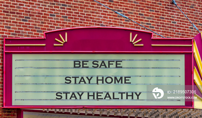 Vintage movie theatre sign with health safety message