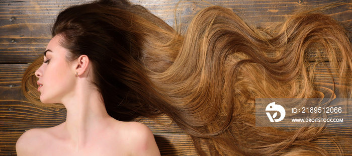 Woman with beautiful long hair on wooden background. Long hair. Beautiful hair coloring woman.