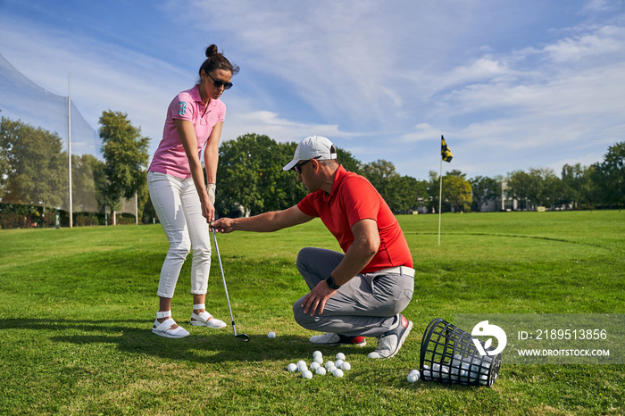 Woman holding a club with both hands