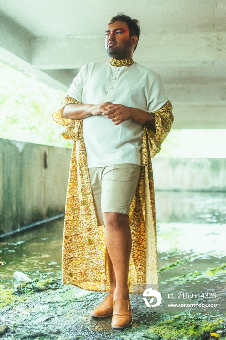 portrait of gay dark skinned indian man in abandoned building