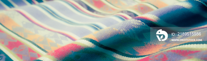 Dancing of colors on fabric, close up