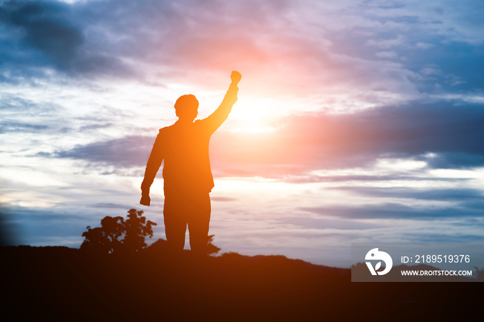 Raised arms man against beautiful sunset.