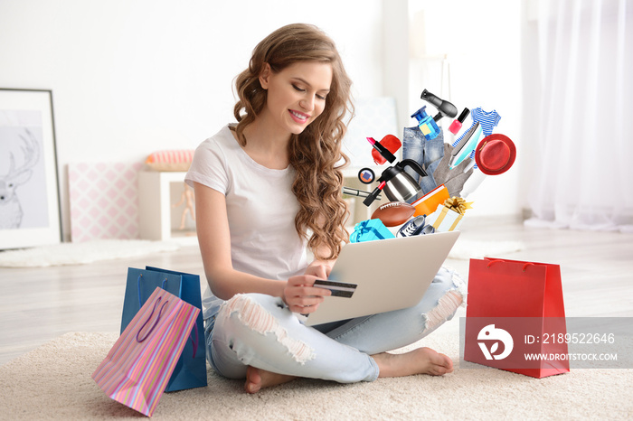 Young woman shopping online with credit card and laptop at home