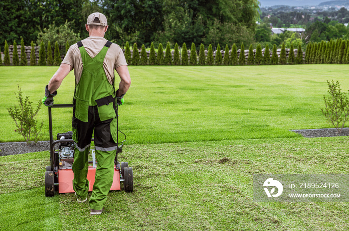 Gardener in His 40s and His Powerful Gasoline Lawn Aerator